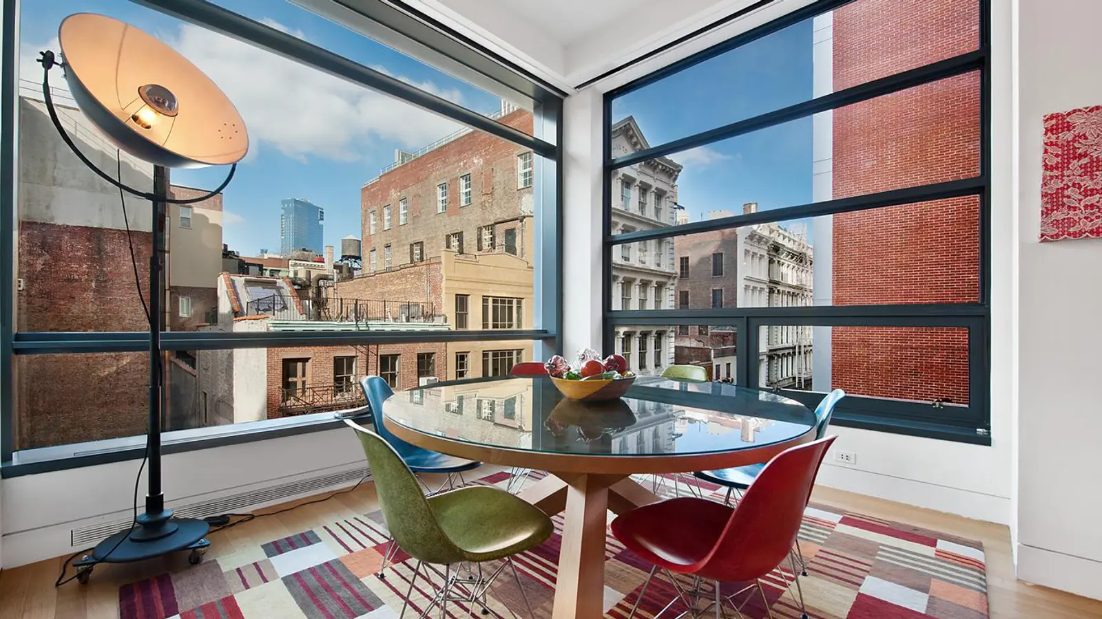 Corner room with operable glass wall and blue-glass transoms